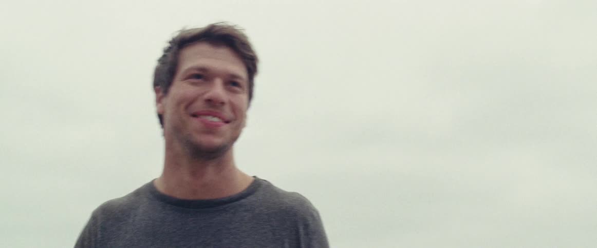 Smiling man standing outside on an overcast day