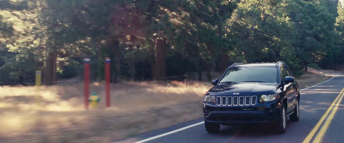 Suv driving down a paved rural road
