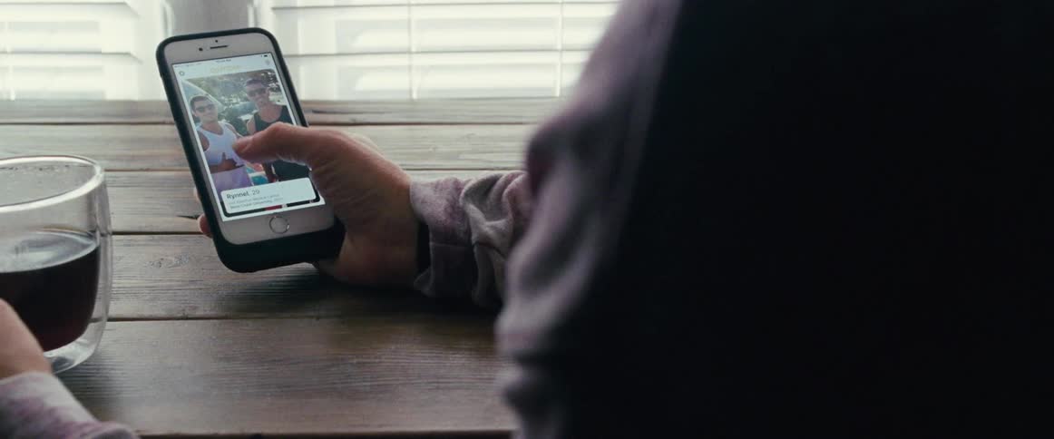 A person scrolling through their phone and looking at pictures