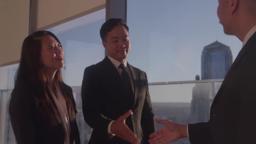 People greet each other and shake hands at a meeting