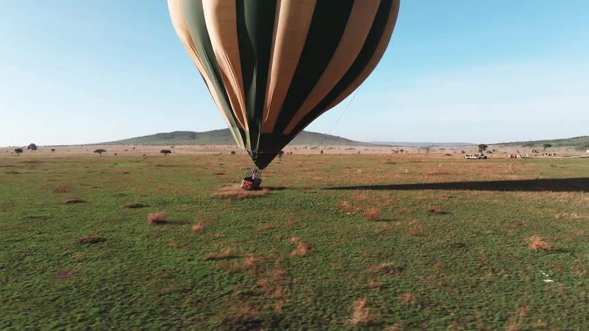 The person rocks in the basket as the hot air balloon drags it
