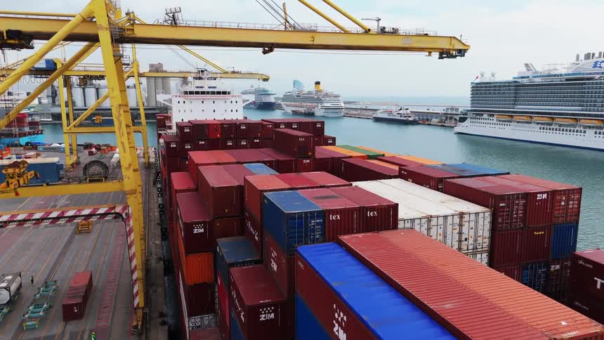 Stacks of colorful hapaglloyd shipping containers tightly packed on a freighters deck ready for transport