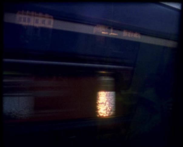 Blue train passing at high speed seen through the window