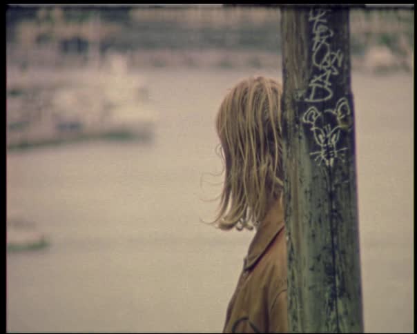 Man standing near a lamp post overlooking the river view
