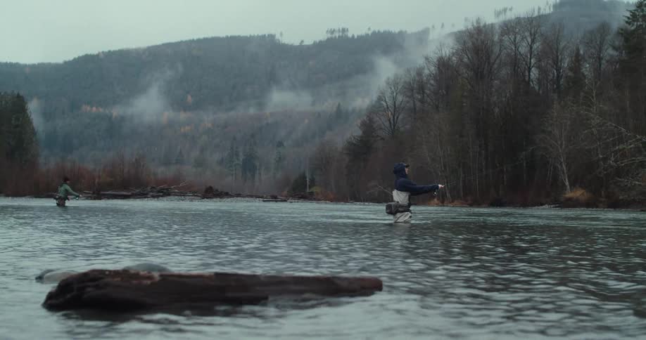 A couple men fishing in a river