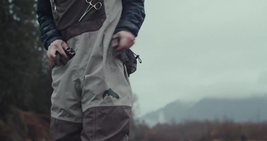 Person adjusting a bag at the waist