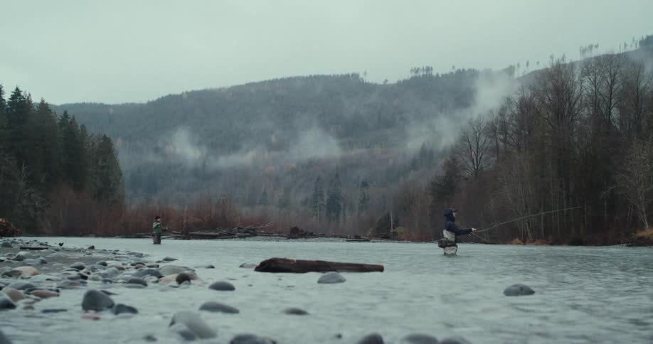 Two people fishing in a river