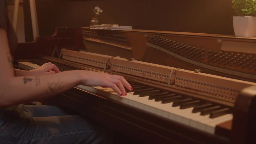 Hands of a woman playing the piano