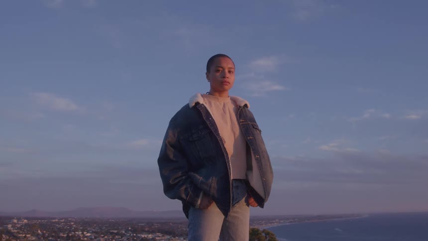 Woman in denim jacket on a hill