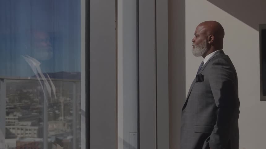 The office worker is taking in the view from the window