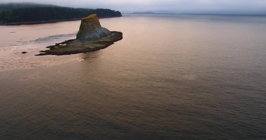 Huge rock mass surrounded by body of water