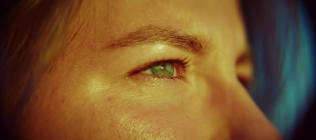 Closeup of the eyes of a woman staring while the breeze ruffles her hair