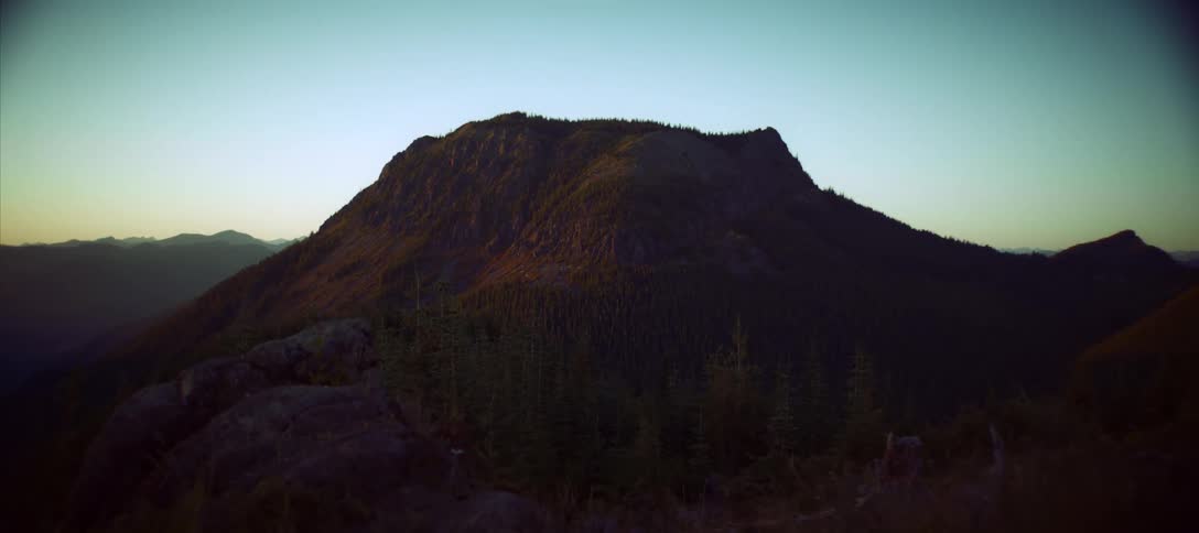 The mountain is covered with green grass