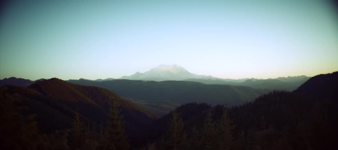 A moutain range in the wilderness at sunset