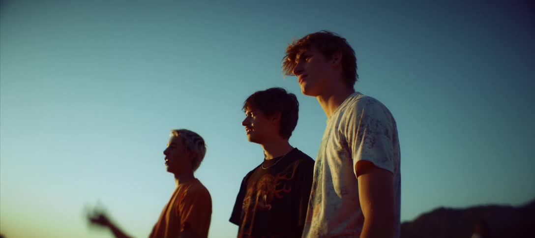 Three young people outdoors and a natural environment