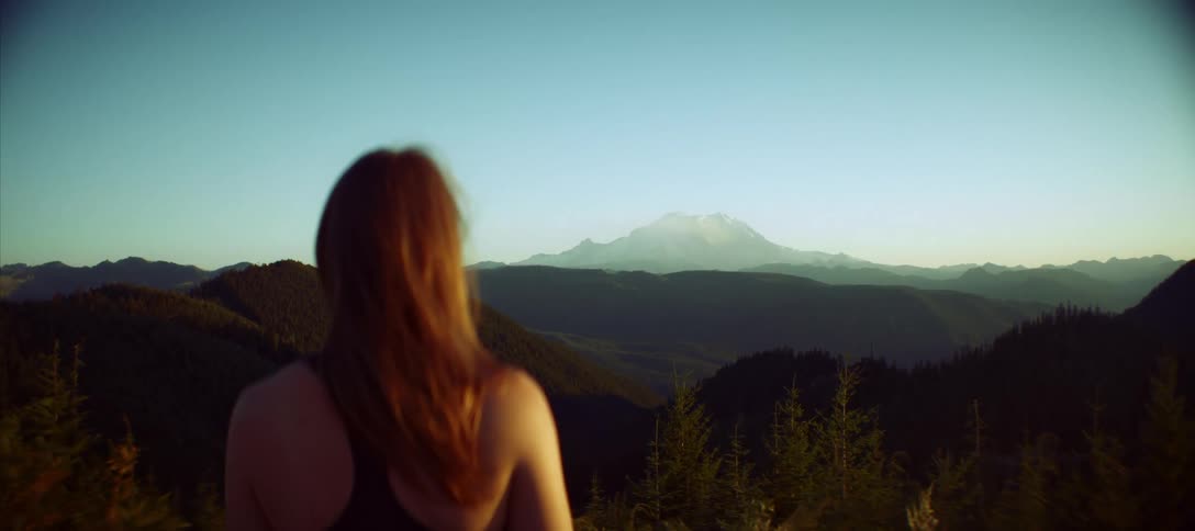 Woman enjoying the mountain landscape at dawn