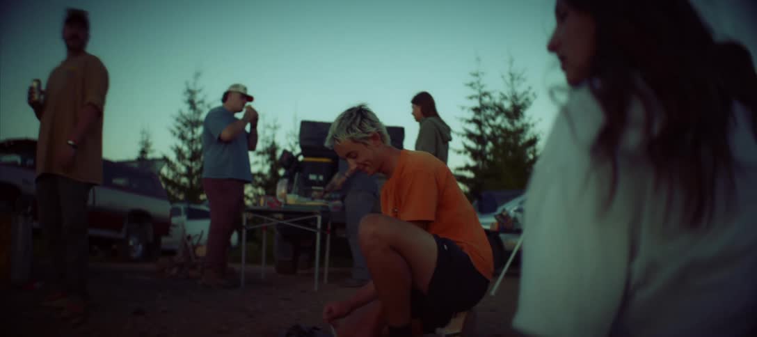 Group of people in a natural environment gathered at a campsite