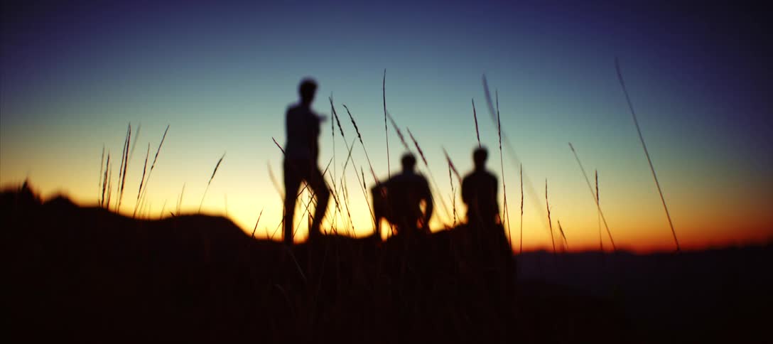 Silhouette of three people in a mountainous environment