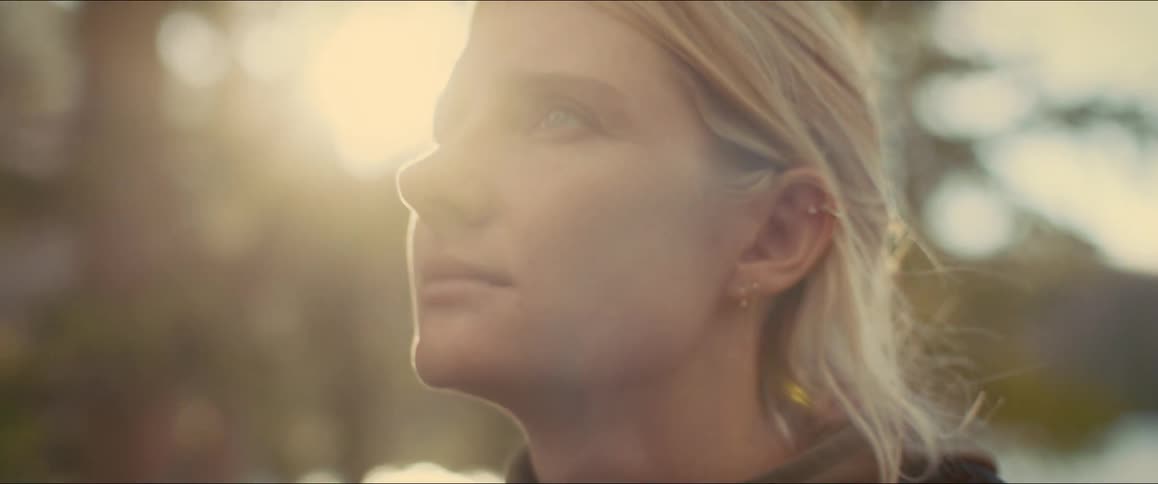 Blonde woman walking in the forest