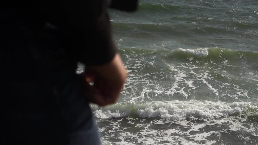 Person stands above a body of water