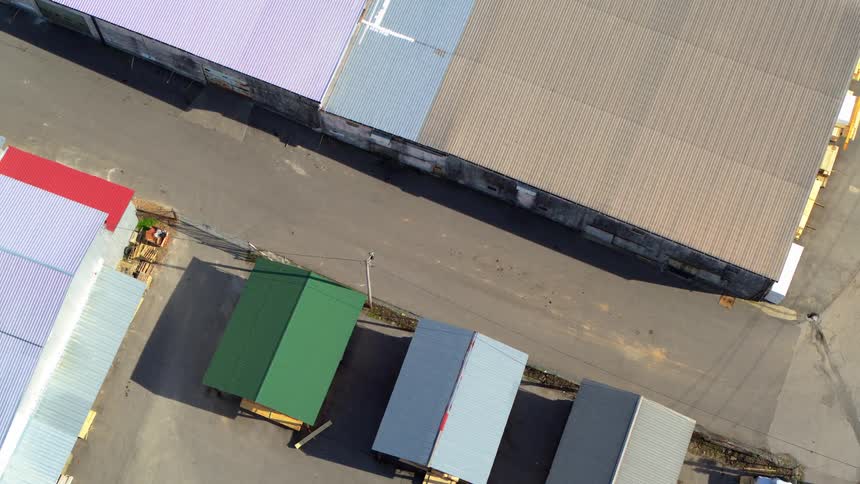Warehouses and small storage units seen from above in an industrial area