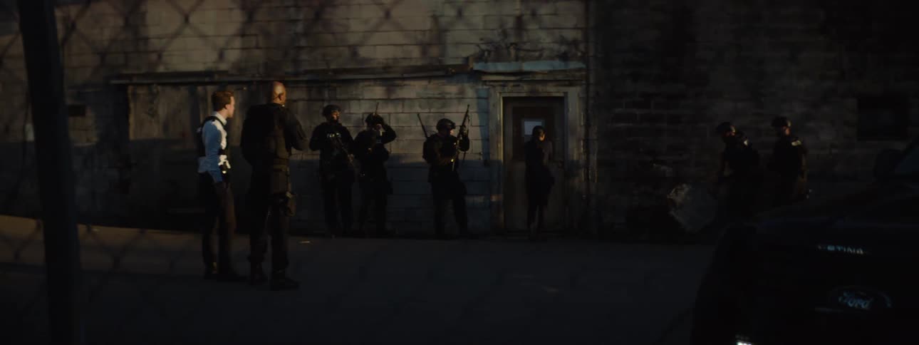 Armed police surround the door to the building