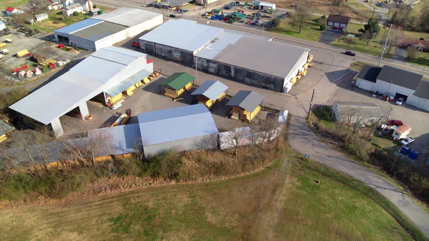 A camera panning down to reveal a business park with several warehouses sheds and other buildings