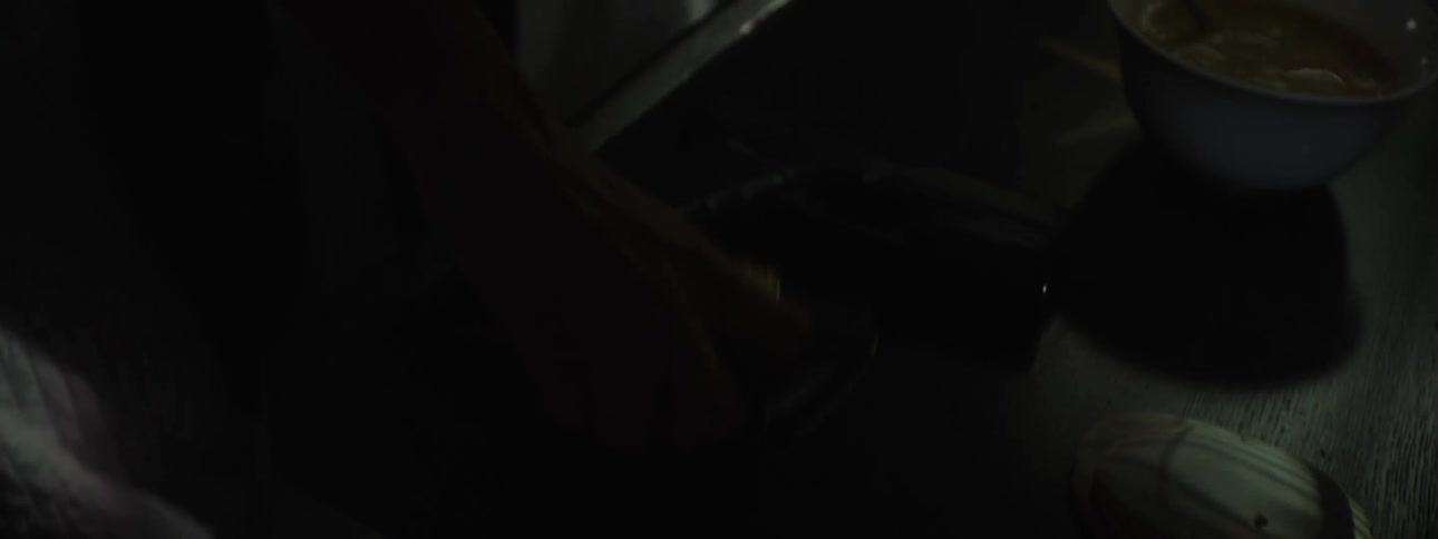 Woman in a dark room taking out her police badge
