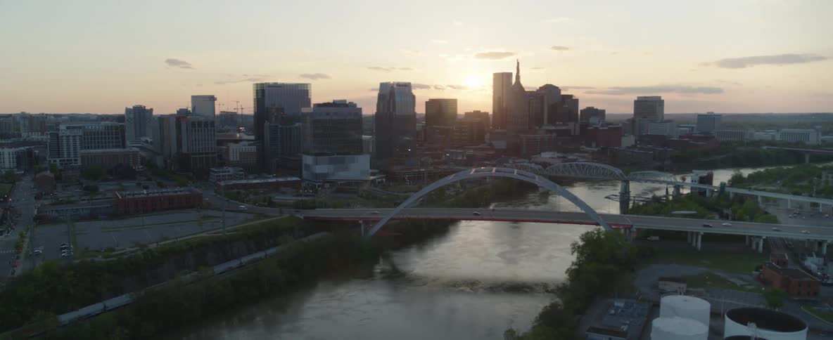 Aerial view of the city at sunset with river and bridges in focus