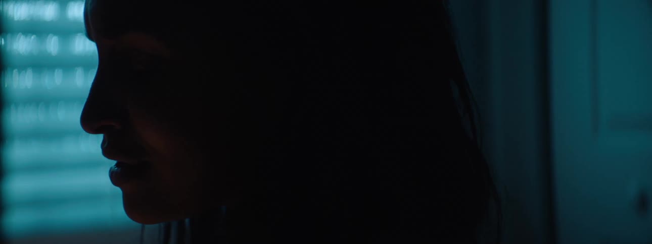 The woman is nervous in the dark room