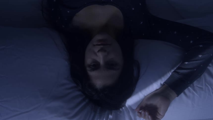 The woman rests in the bed