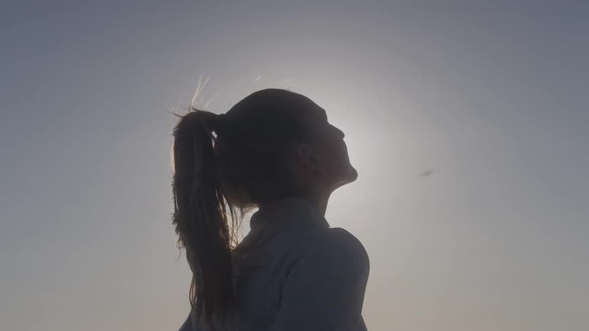 Woman outdoors looking at the sky