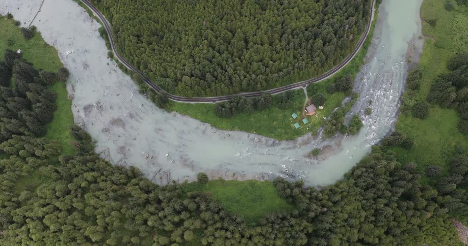 Aerial view of a winding river surrounded by dense forest