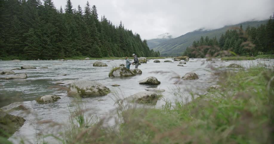 Two people fishing in a river