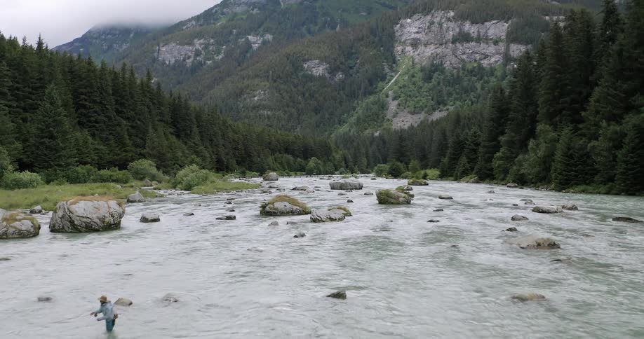 Person fly fishing in the shallow river