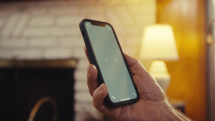 Hand holds a smartphone