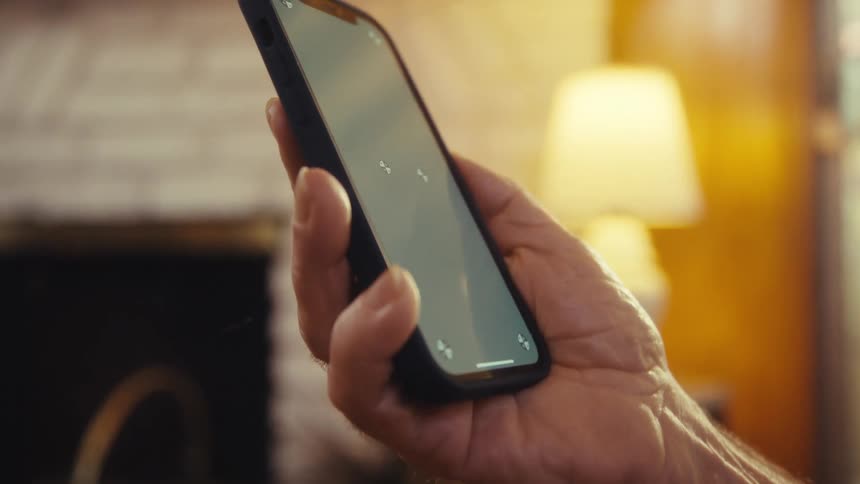 Elderly man interacting with a smartphone