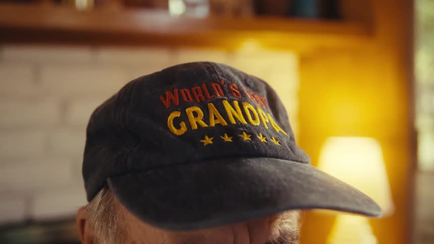 Black cap with embroidered text worlds best grandpa