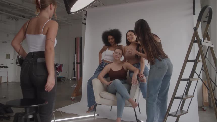Models get their makeup done and pose for photos in the studio
