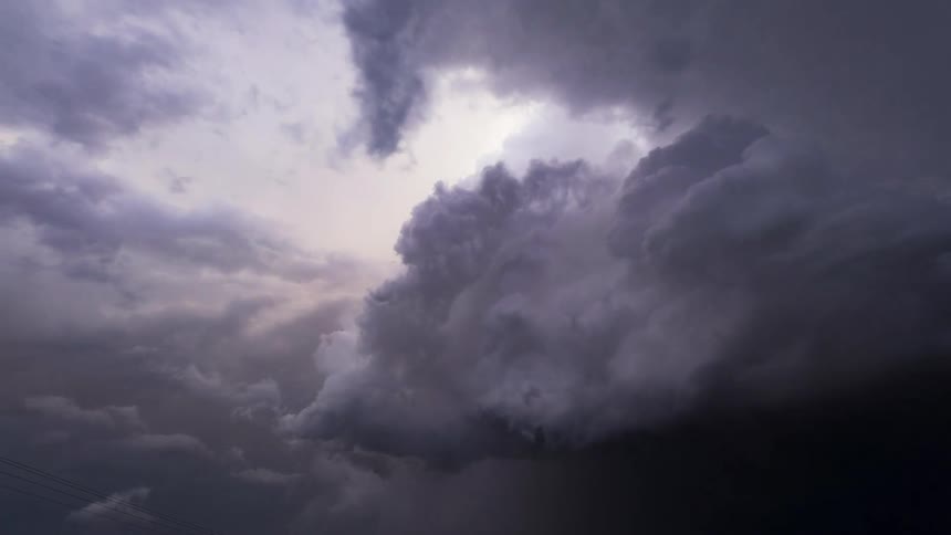 The clouds in the sky move and change formation as the weather darkens