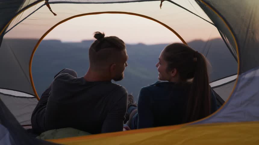 A couple camping in a tent