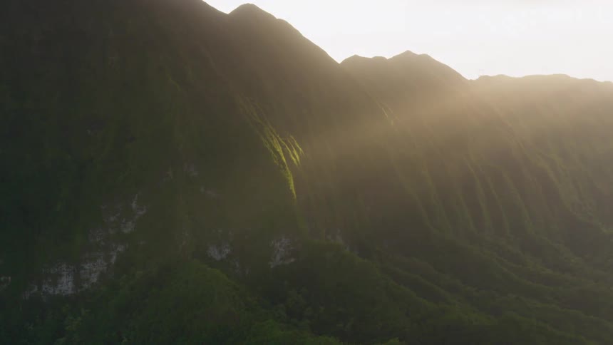 The sun shines at a natural landscape mountain full of moss