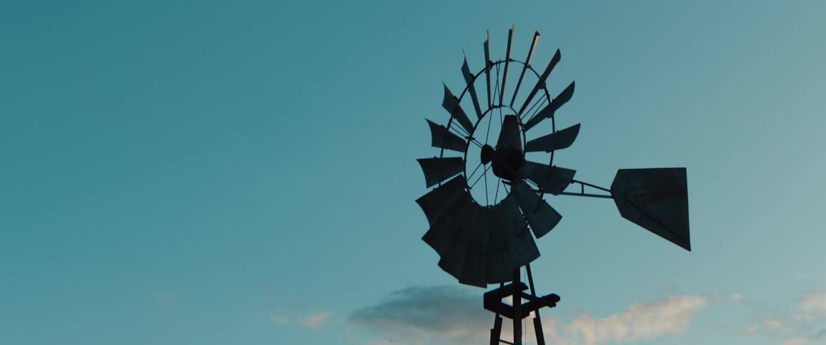 Ancient windmill turbine fan standing still under the bright midday sun
