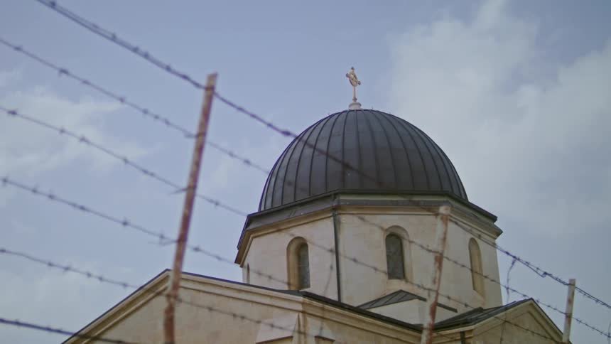 A barbed wire fence beside a building
