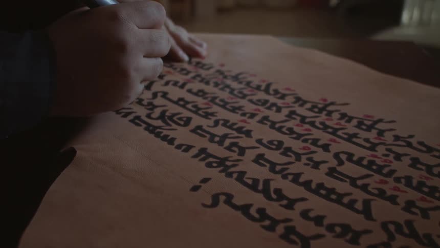 A man uses a marker to write on a piece of paper