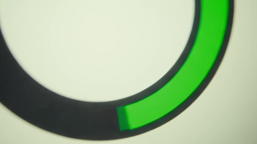 A screen displays a green progress ring on a white background
