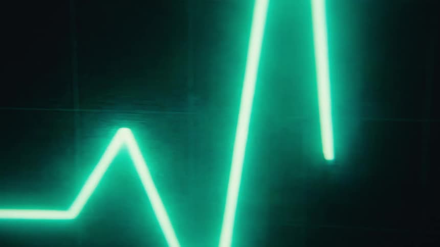 Bright blue line forms peaks and valleys in a graph plotted against a background grid on a digital screen