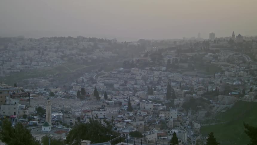 Fog sits over this town at sunset