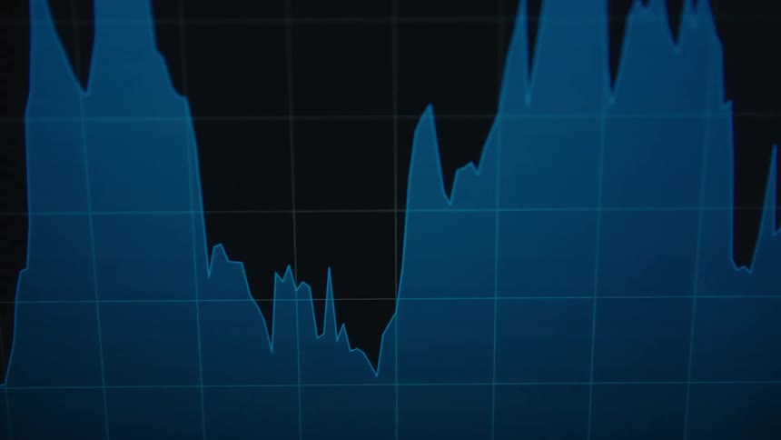 Blue colors the area under the line in a graph contrasting with the black background on a computer screen