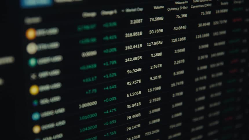 A long list of cryptocurrencies and numbers are listed on the computer screen